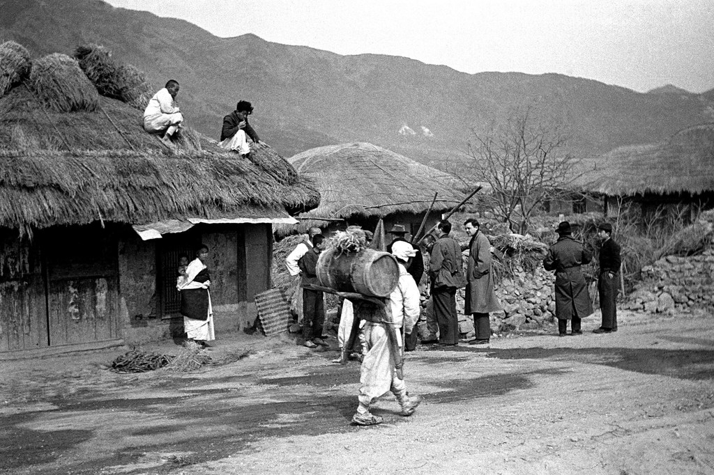 In this photo from 1951, members of the UN Commission for the Unification and Rehabilitation of Korea can be seen visiting a Korean village.